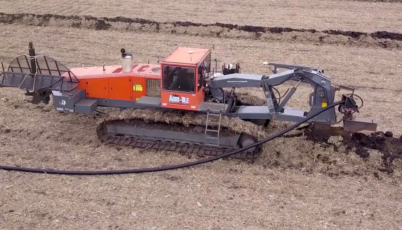 Excavator digging a drainage trench